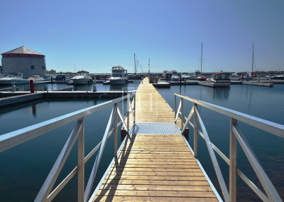 Wide angle view of Kingston's Confederation Basin Harbour pier stretching into the Horizon.