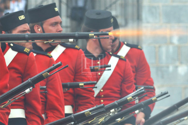 Fort Henry Guard in red jackets musket salute during Sunset Ceremony in Kingston Ontario Canada